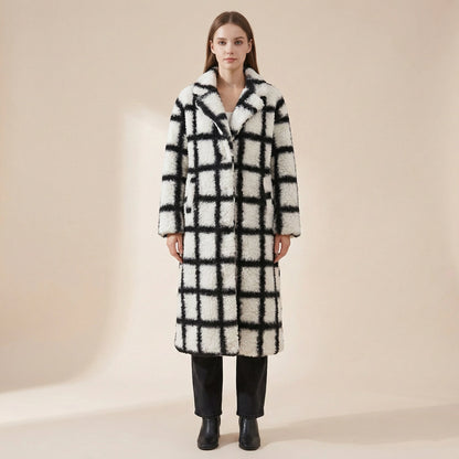 Woman wearing a checkered coat on a beige background