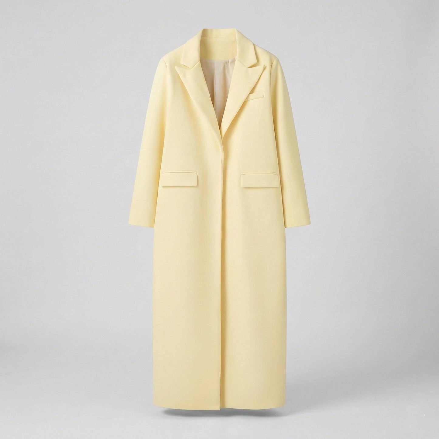 Light yellow coat on a gray background