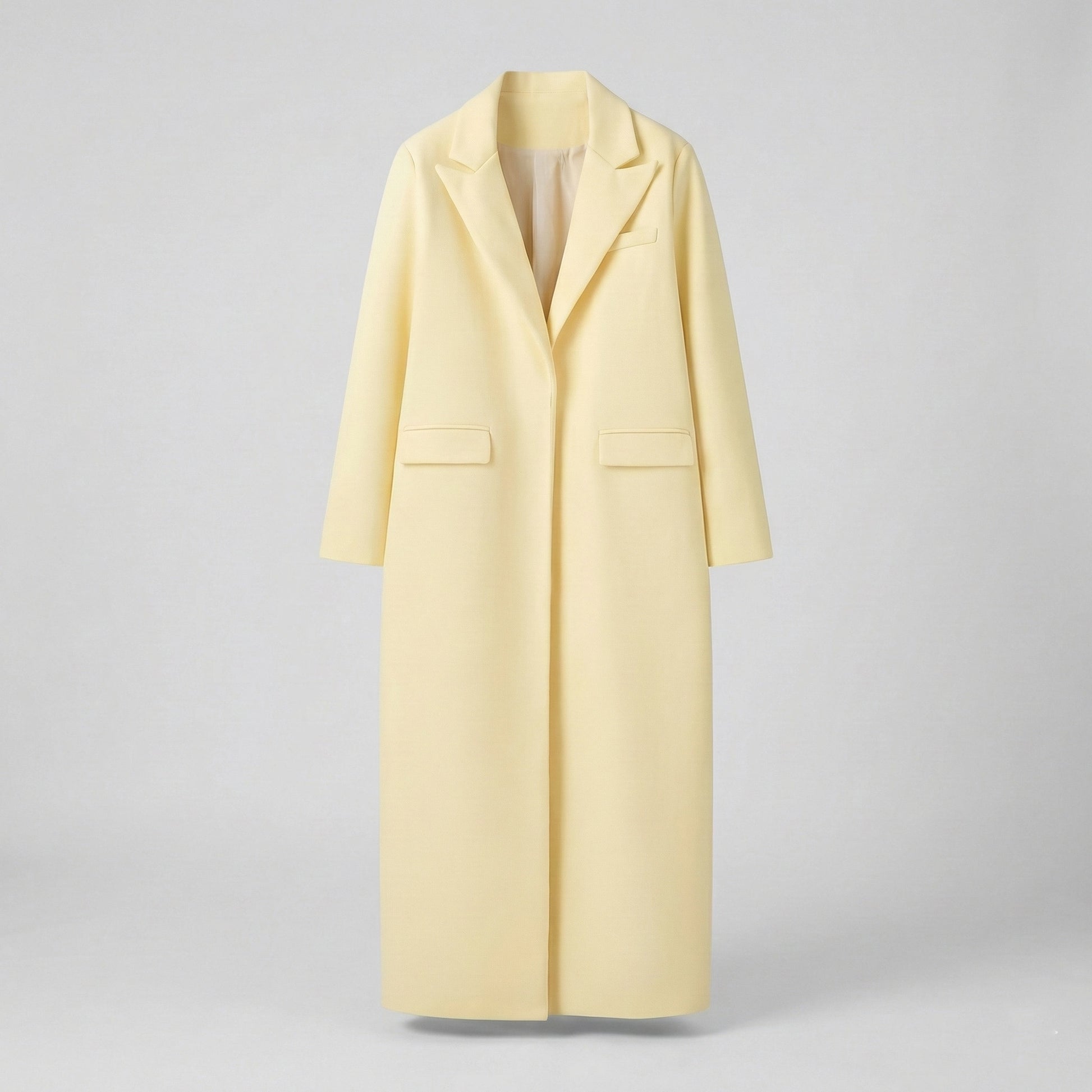 Light yellow coat on a gray background
