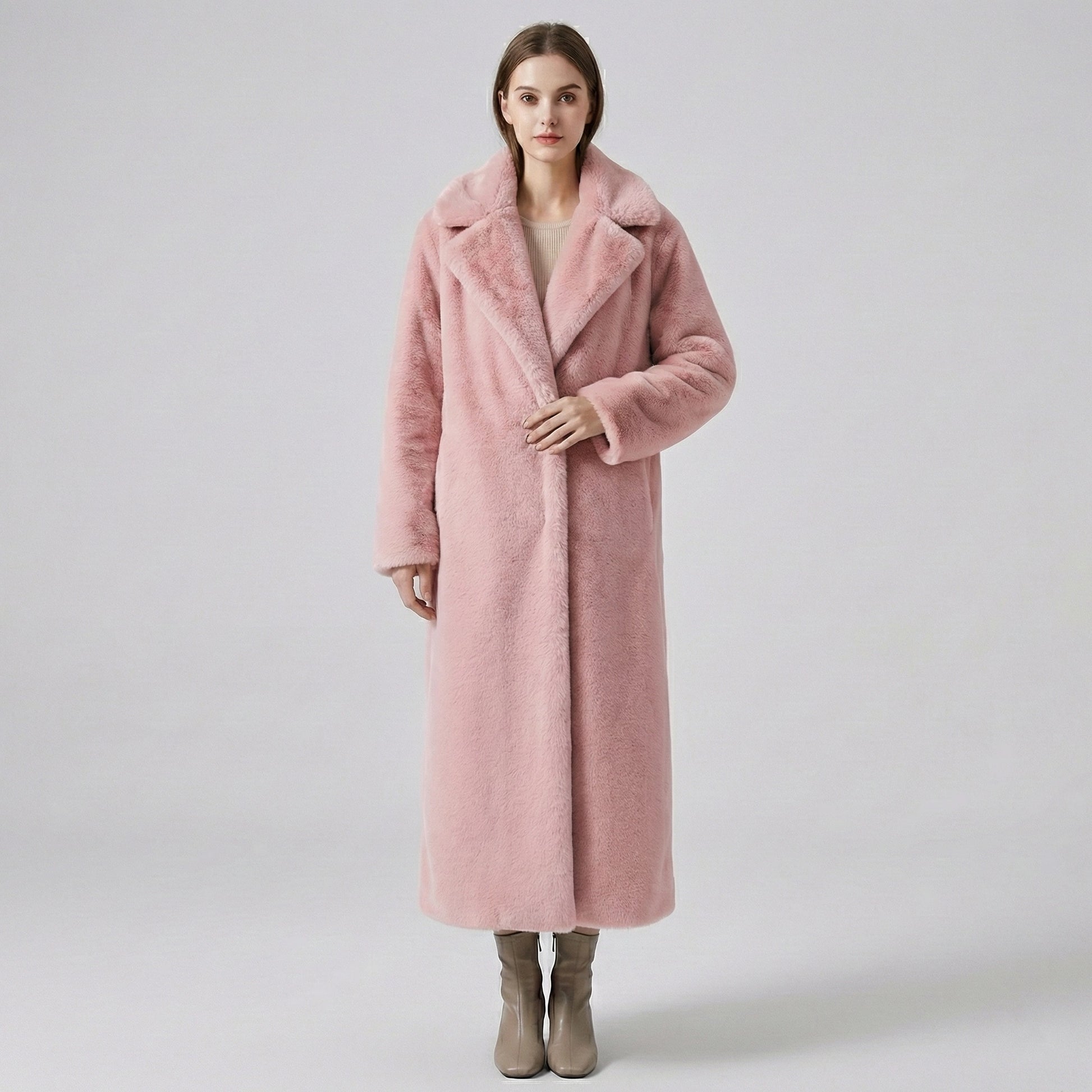 Woman wearing a pink coat on a plain background