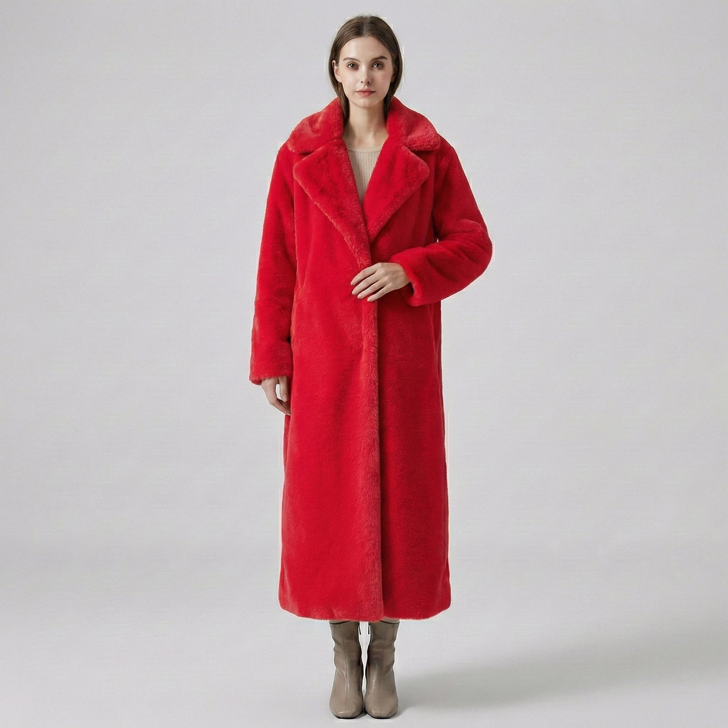 Person wearing a red coat on a plain background